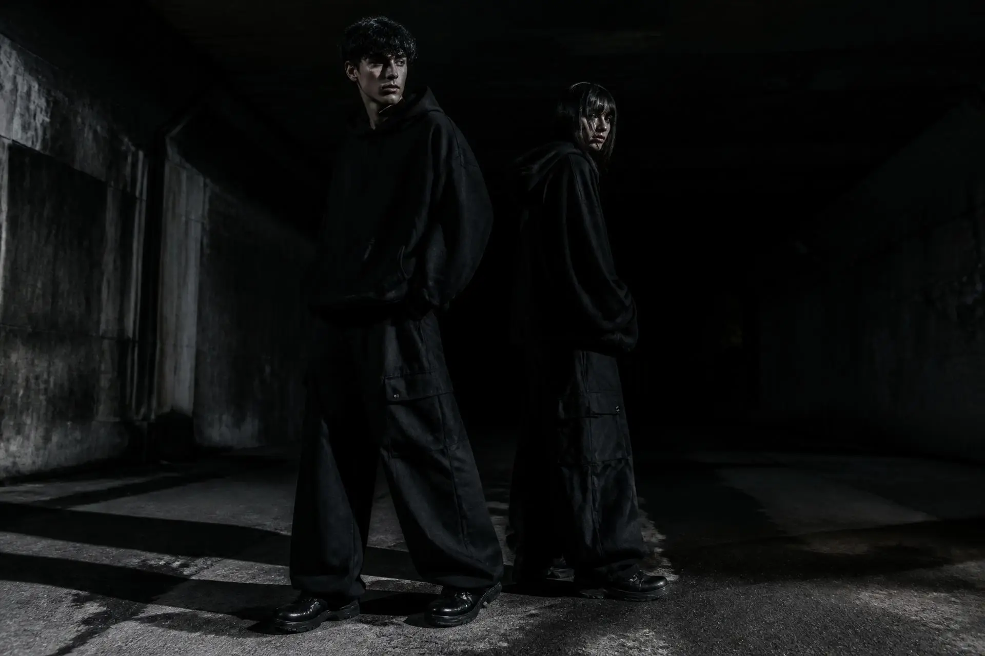FLUX ATTIRE campaign — two models in oversized hoodies in an industrial space